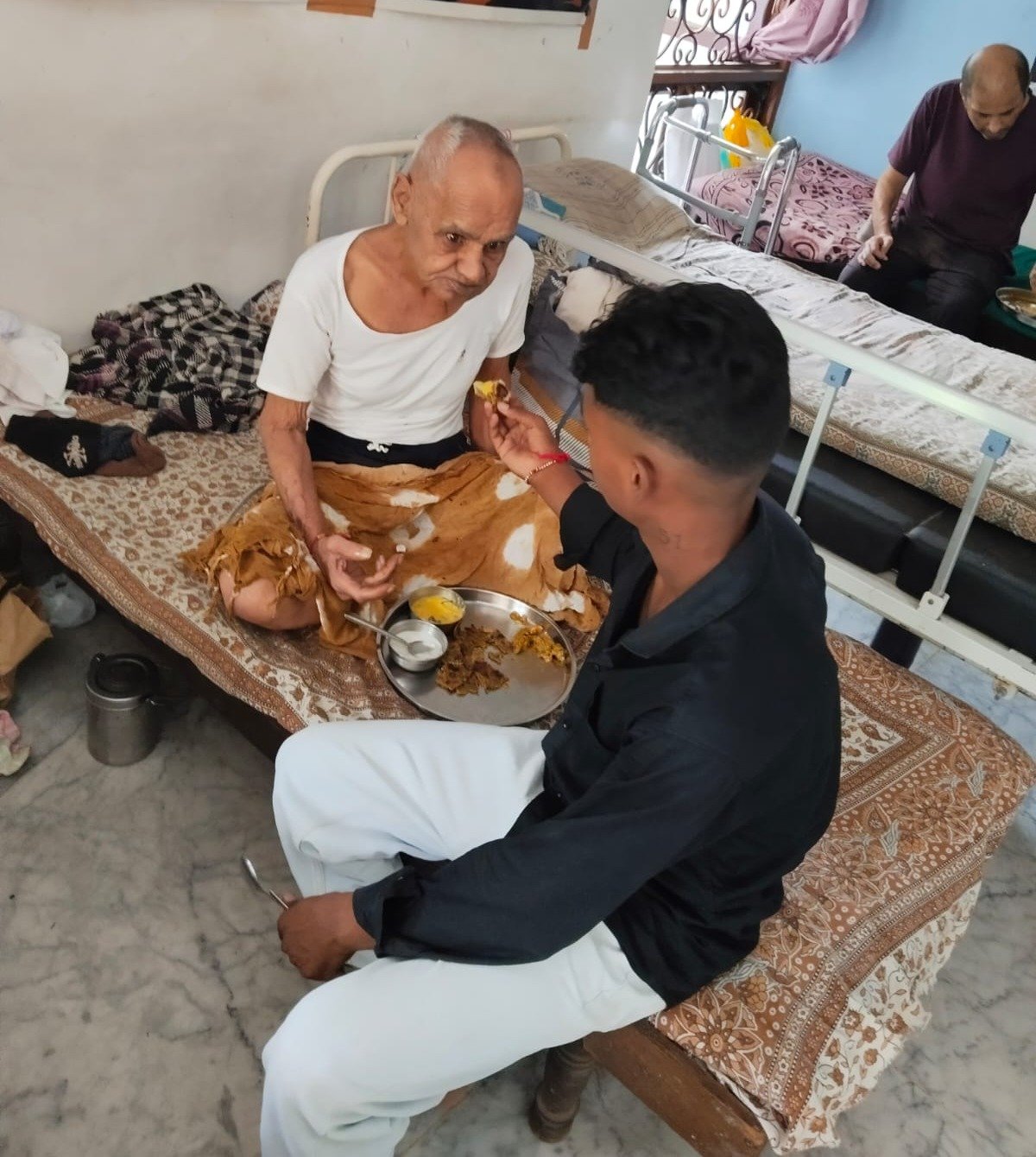 A caregiver lovingly feeding an elder