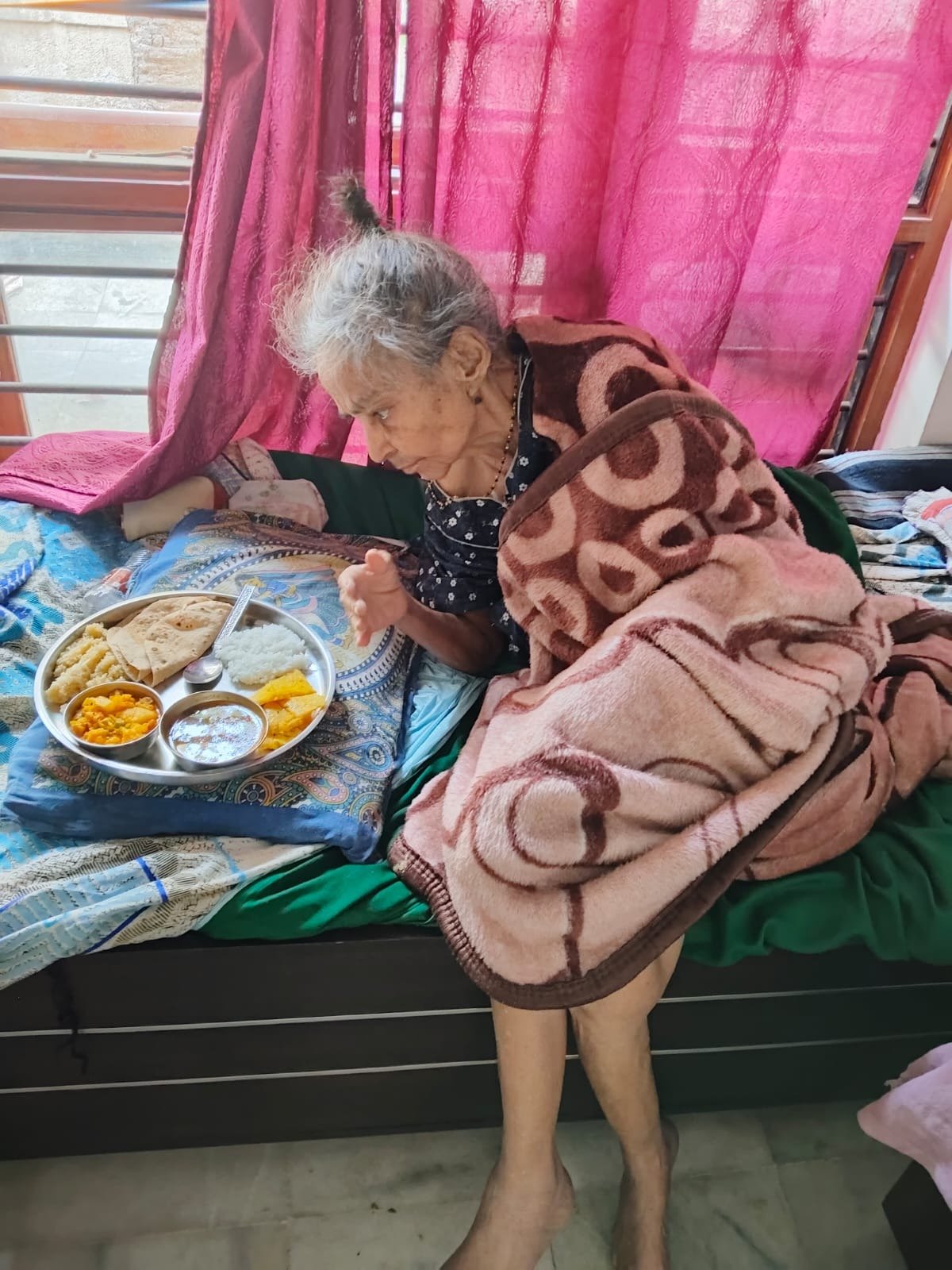 An elderly woman having her meal